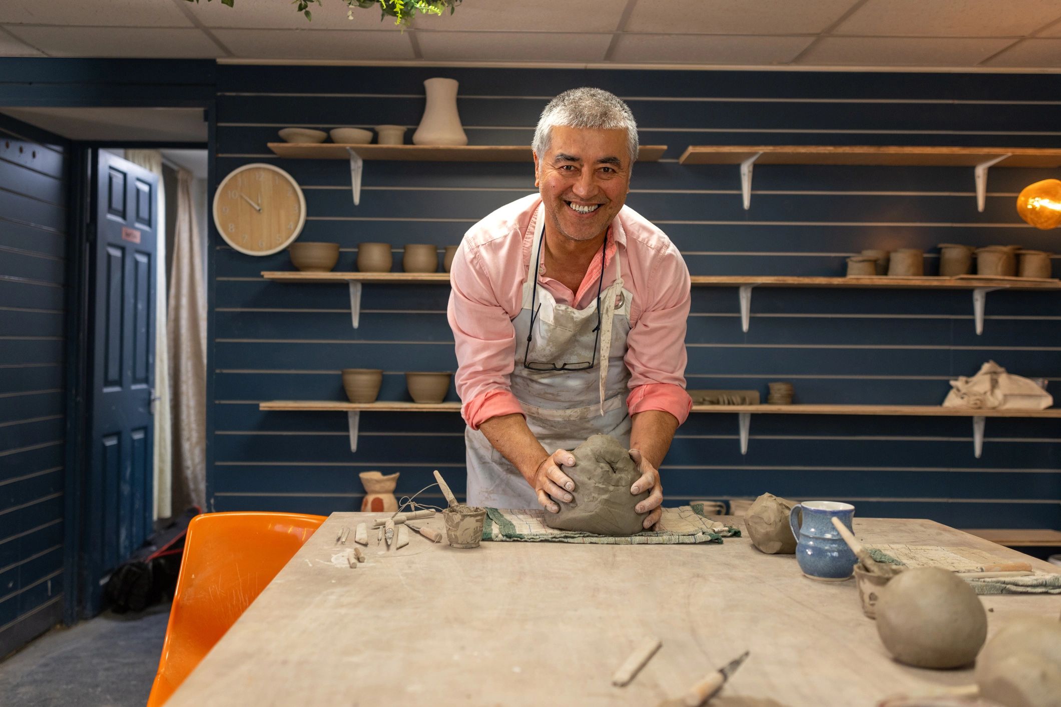 Potter shaping clay in a pottery studio